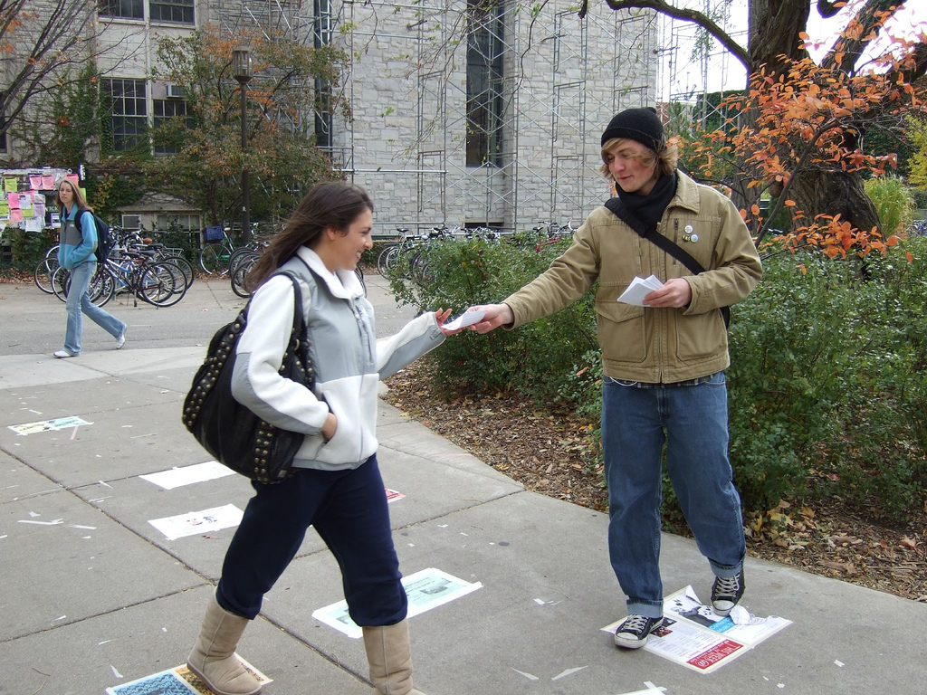 Man giving out adverts on the street.